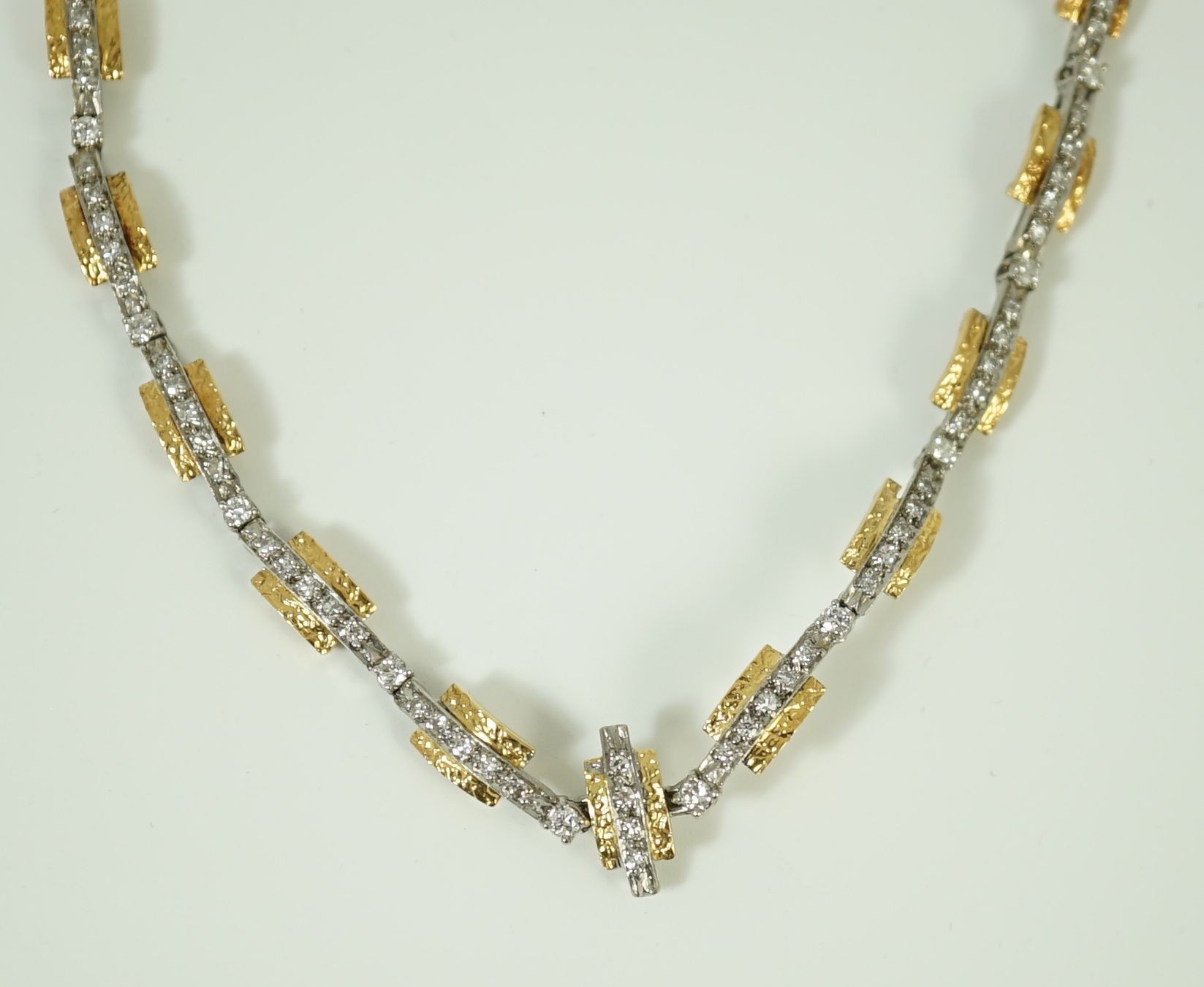 A 20th century two colour gold and diamond set necklace